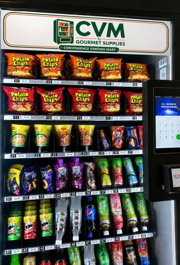 A Vending Mart combo machine from CVM by Gourmet Supplies, a single glass-fronted unit stocked with snacks on the upper shelves and chilled drinks below